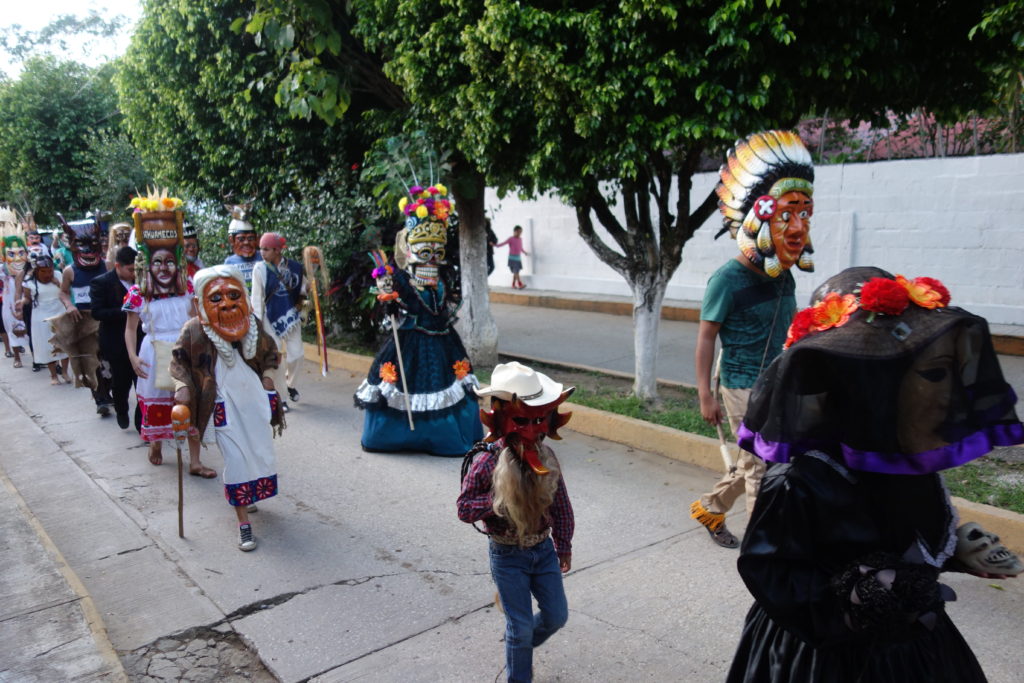 Huehues parade through town for Xantolo Day of the Dead celebrations in  the Huasteca Potosina.